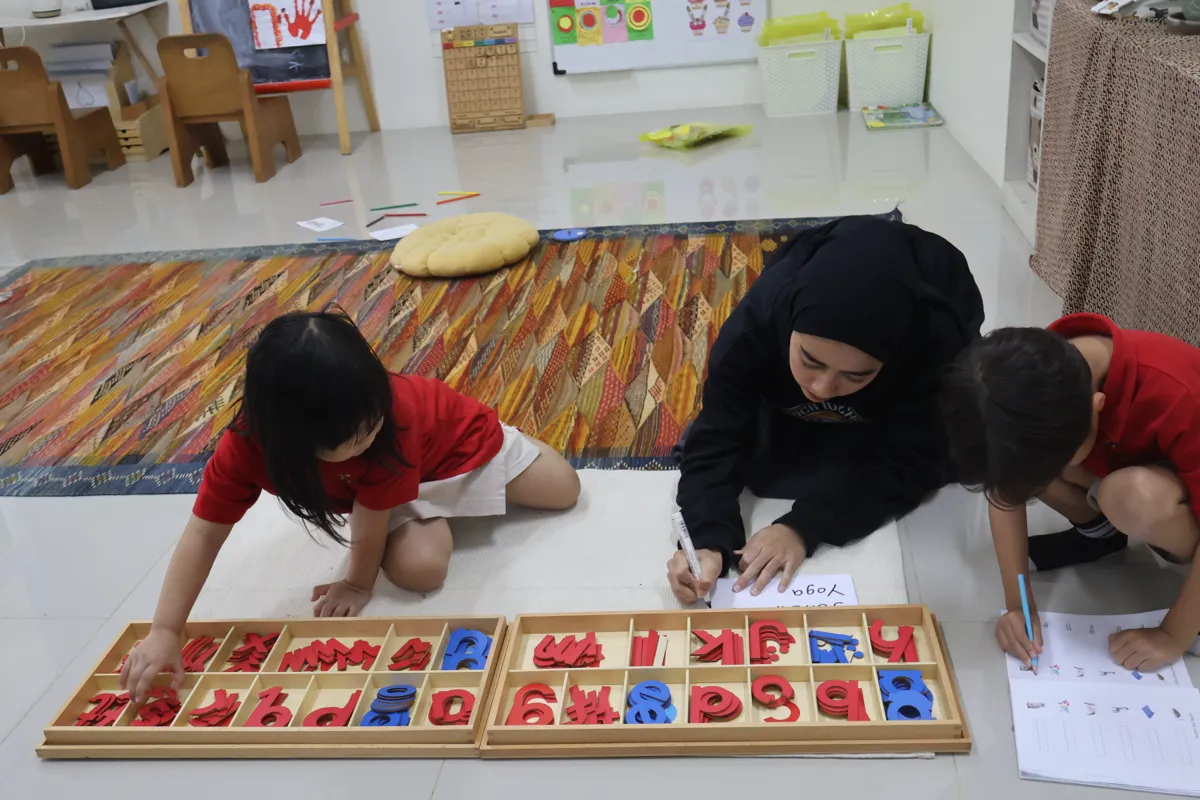 A child exploring a purposeful learning activity at Pascal Montessori