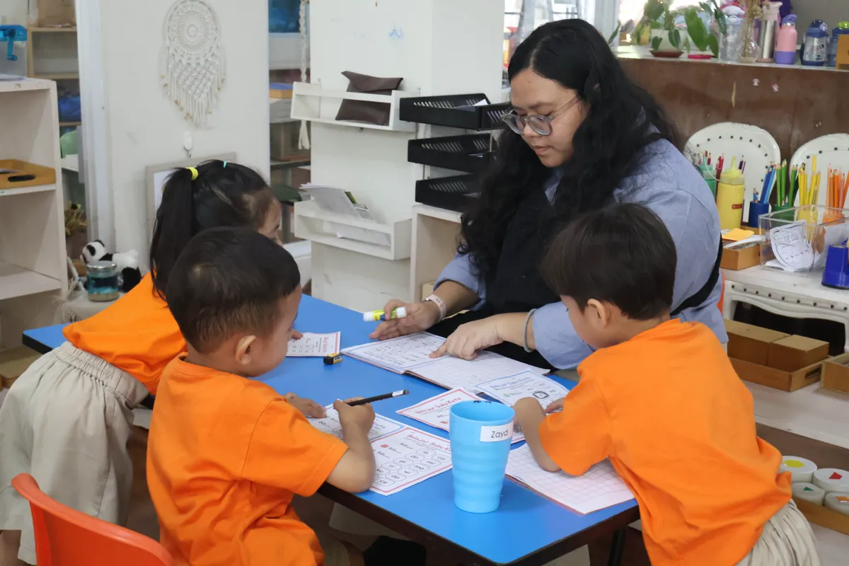 A Pascal Montessori child learning through hands-on Montessori materials